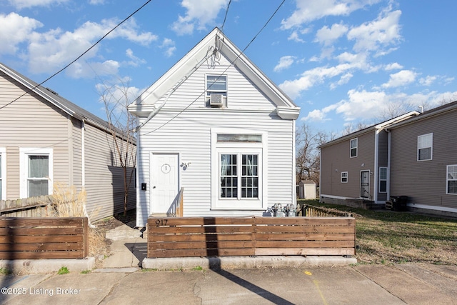 shotgun-style home with a fenced front yard and entry steps