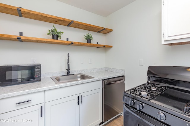 kitchen featuring white cabinets, open shelves, black appliances, and a sink