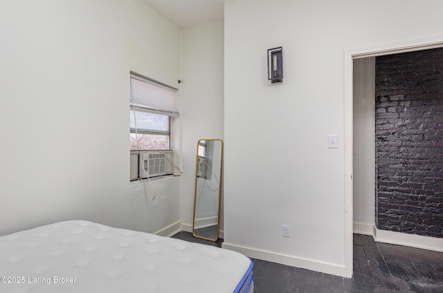 bedroom featuring cooling unit, baseboards, and dark wood finished floors