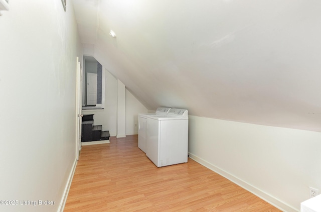 laundry area featuring light wood finished floors, independent washer and dryer, and baseboards