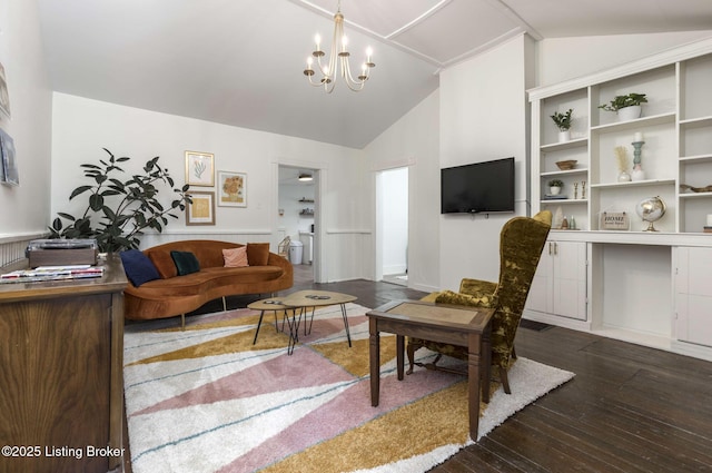 living area with an inviting chandelier, lofted ceiling, and hardwood / wood-style floors