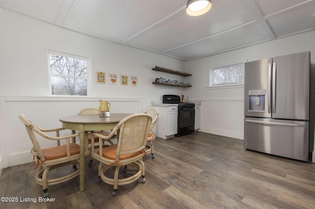 dining room featuring dark wood finished floors and wainscoting