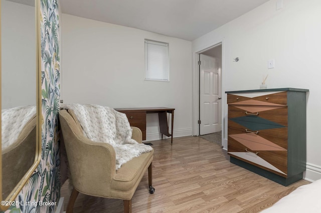 sitting room featuring baseboards and wood finished floors