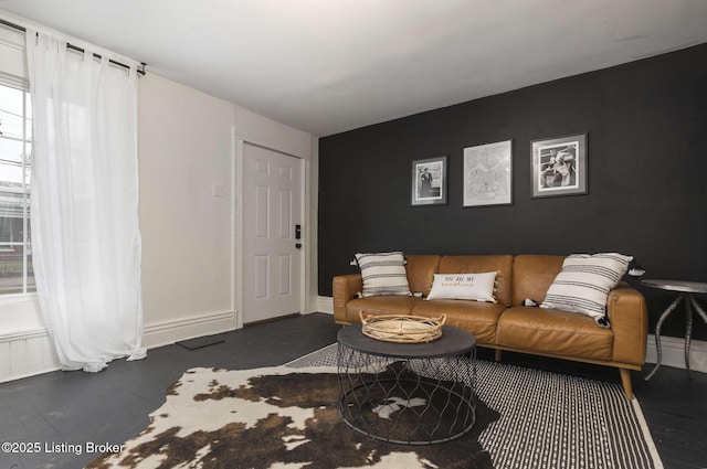 living area featuring baseboards