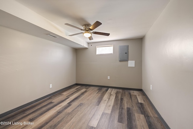 spare room featuring visible vents, ceiling fan, baseboards, electric panel, and wood finished floors