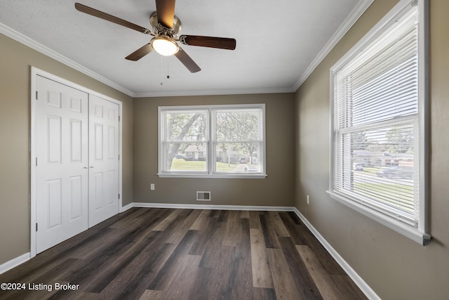 unfurnished bedroom featuring a closet, visible vents, baseboards, and dark wood-style floors