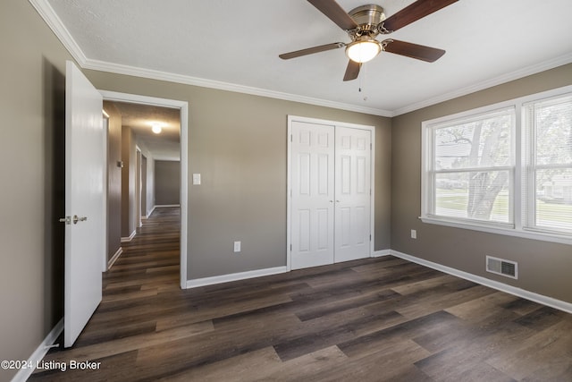 unfurnished bedroom with visible vents, baseboards, and dark wood-style flooring