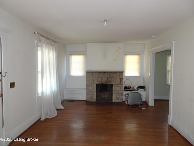 7 Hill Top Ct, Louisville, KY 40214 - unfurnished living room featuring a stone fireplace, baseboards, and wood finished floors