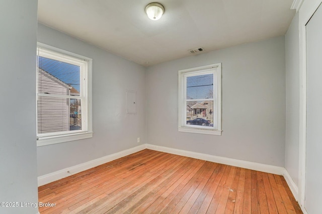 unfurnished room with visible vents, baseboards, and light wood-type flooring