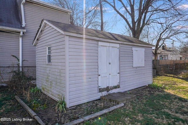 view of shed featuring fence