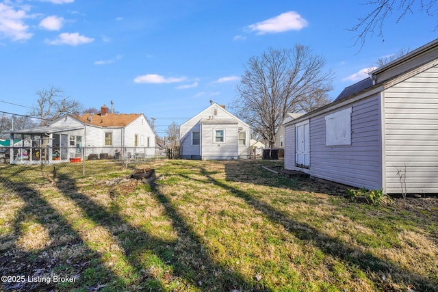 view of yard featuring an outdoor structure and fence