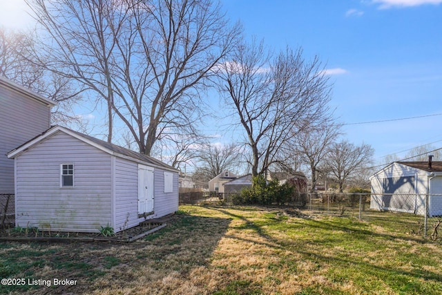 view of yard with an outdoor structure and a fenced backyard