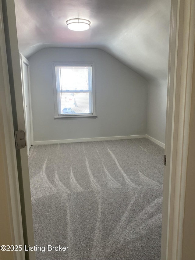 bonus room with vaulted ceiling, carpet, and baseboards