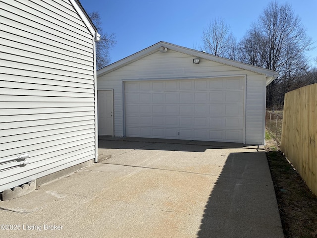 detached garage featuring fence