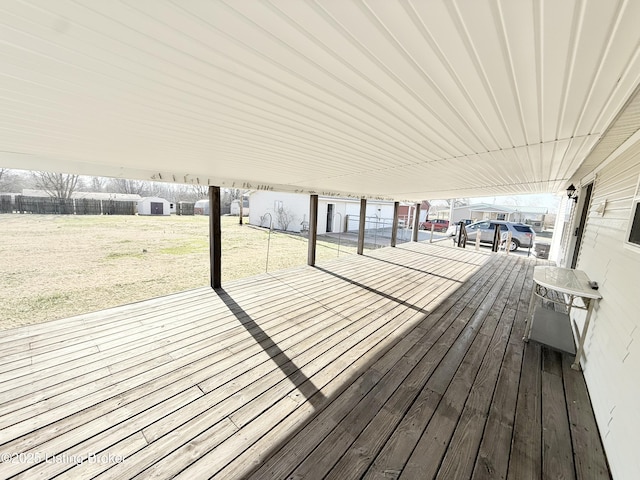 wooden deck with a yard and fence