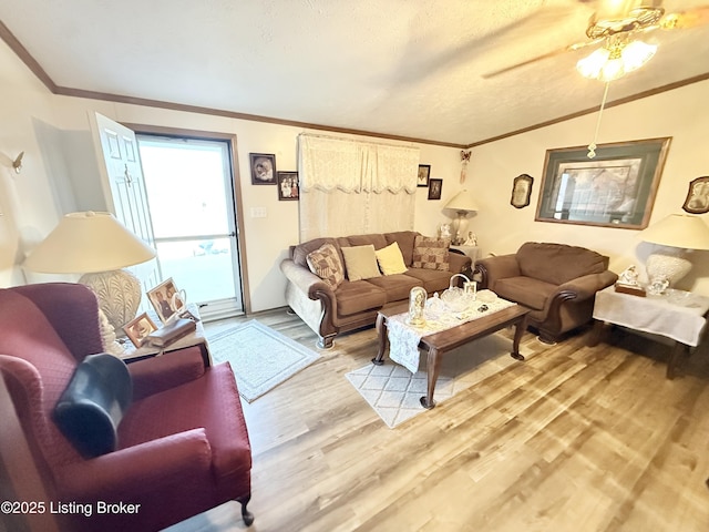 living area with vaulted ceiling, wood finished floors, a ceiling fan, and ornamental molding