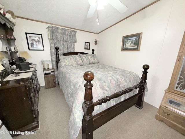 carpeted bedroom with ornamental molding and a ceiling fan