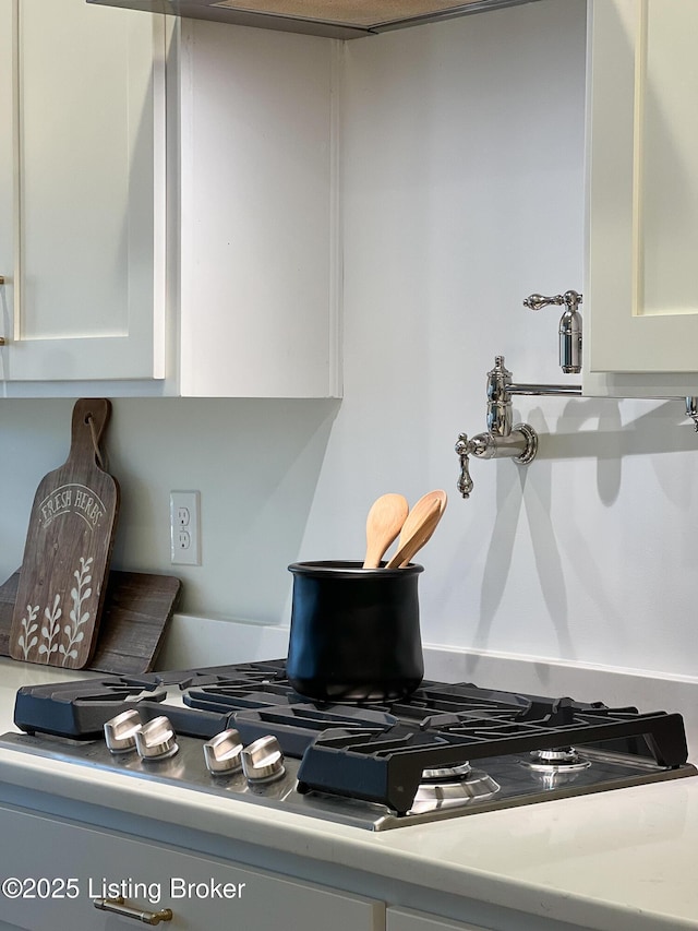 interior details featuring white cabinets and light countertops