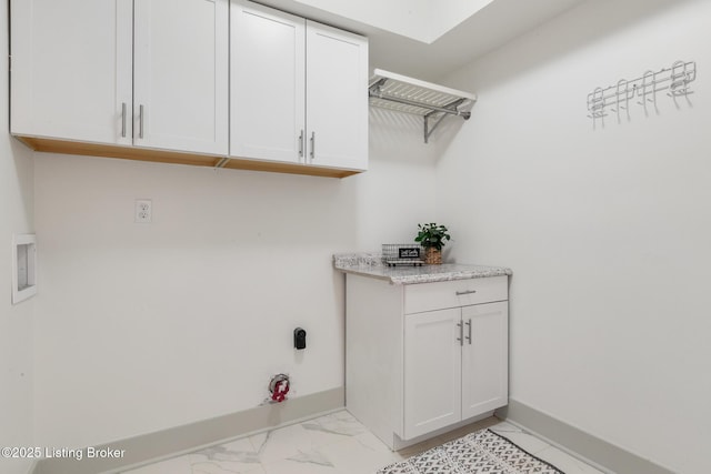 laundry room with washer hookup, cabinet space, marble finish floor, and baseboards