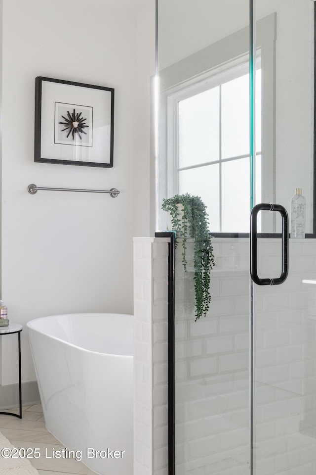 bathroom featuring a freestanding bath and a stall shower