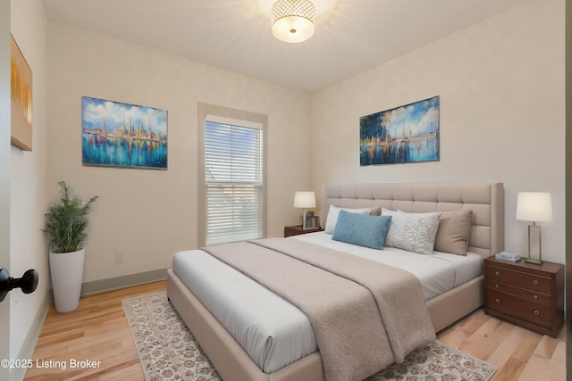 bedroom featuring light wood-style flooring and baseboards