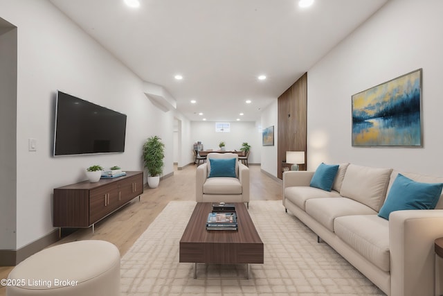 living room with recessed lighting and light wood-type flooring