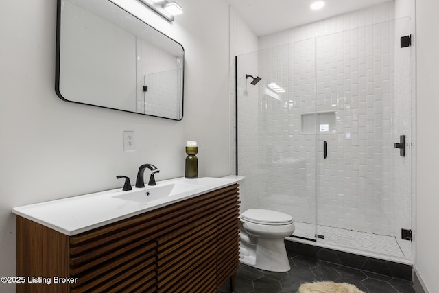 full bath with tile patterned flooring, a shower stall, toilet, and vanity