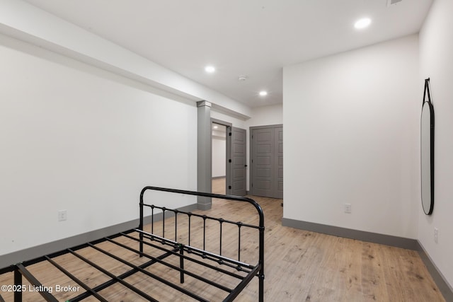 interior space with recessed lighting, light wood-type flooring, and baseboards