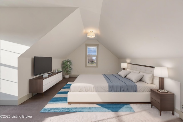 bedroom with baseboards and vaulted ceiling