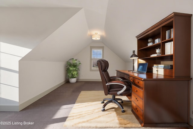 office area featuring carpet flooring, baseboards, and vaulted ceiling