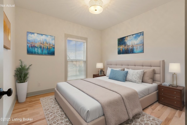 bedroom with baseboards and light wood-type flooring