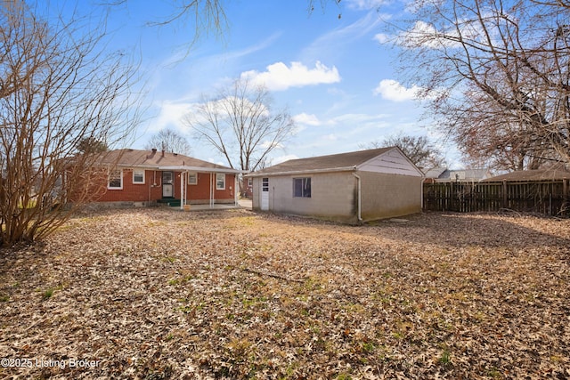 back of house with an outdoor structure and fence