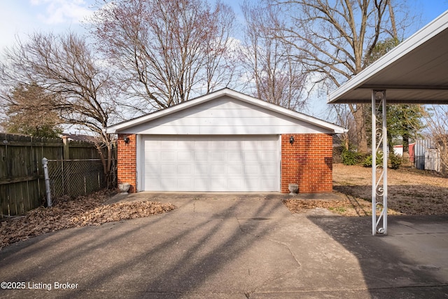 detached garage featuring fence