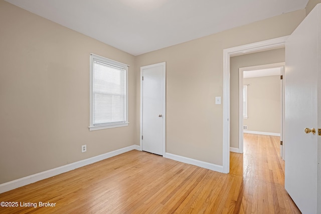 unfurnished bedroom with baseboards and light wood-style floors