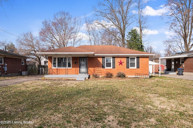 view of front of property with a front yard, brick siding, and aphalt driveway