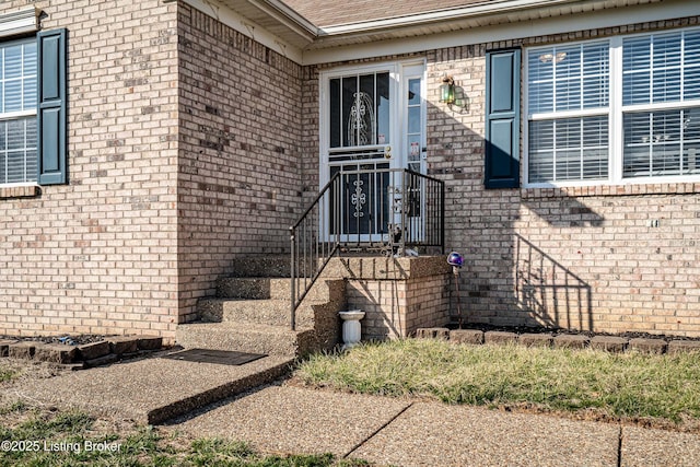 property entrance with brick siding