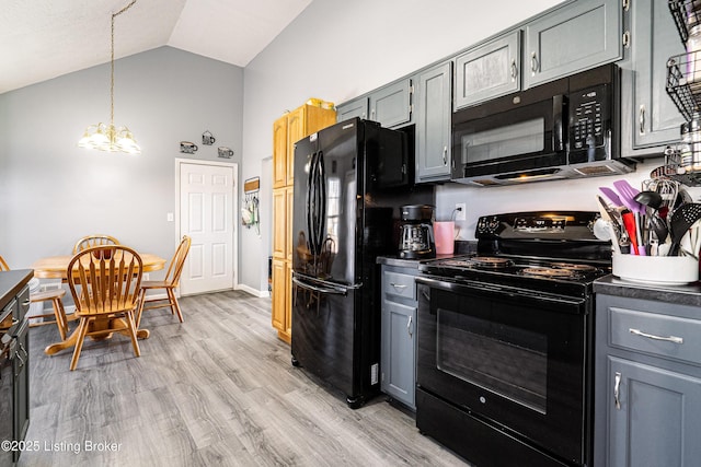 kitchen with black appliances, light wood-style flooring, gray cabinets, lofted ceiling, and a chandelier