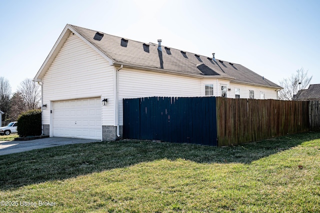 view of property exterior featuring concrete driveway, a yard, fence, and a garage