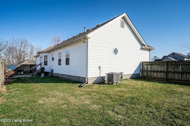 view of side of home with entry steps, a yard, a fenced backyard, and central AC