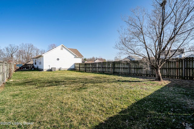 view of yard with central air condition unit and a fenced backyard