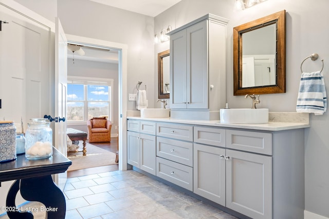 full bathroom with double vanity and a sink