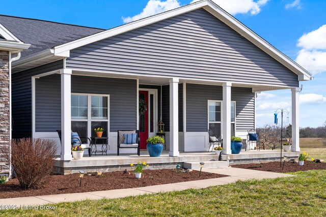 view of front of home with a porch and roof with shingles