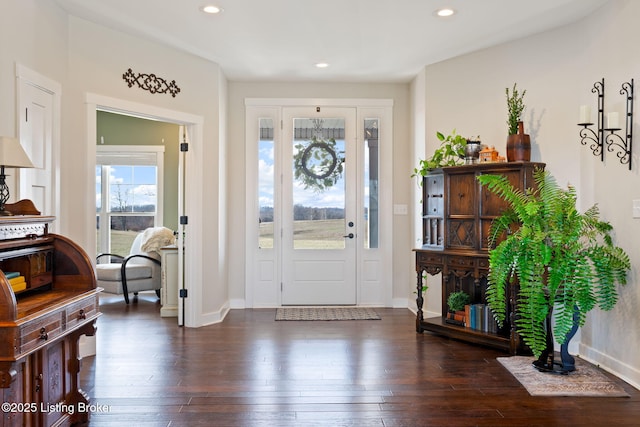 foyer entrance with recessed lighting, baseboards, and dark wood finished floors