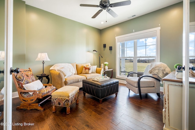 living area featuring ceiling fan, visible vents, and wood finished floors