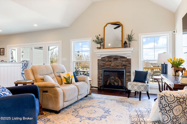 living area with recessed lighting, lofted ceiling, wood finished floors, and a fireplace