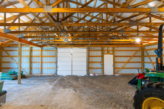 garage with a garage door opener and metal wall