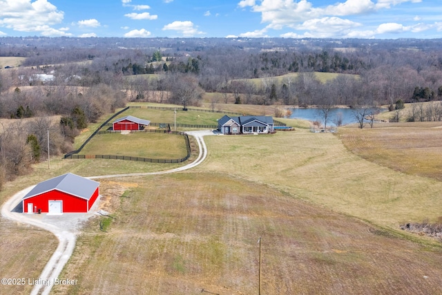 drone / aerial view featuring a rural view, a wooded view, and a water view