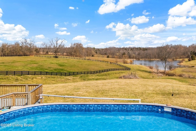 pool with a yard, a rural view, and a water view