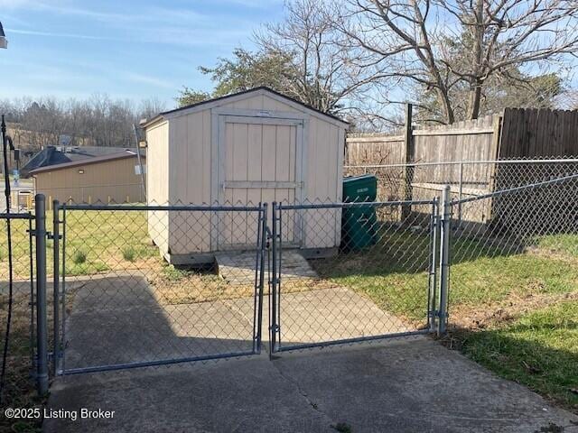 view of shed featuring a gate and fence