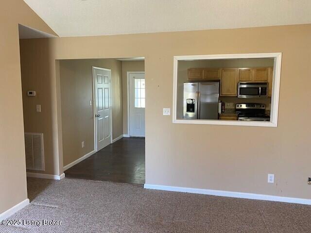 kitchen with visible vents, brown cabinets, carpet, appliances with stainless steel finishes, and baseboards